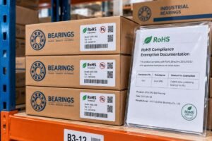 A stack of industrial bearing boxes with visible RoHS compliance labels and exemption documentation on a warehouse shelf