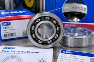 Close-up inspection of genuine SKF deep-groove ball bearings for elevator traction machines showing clear laser-etched markings and packaging details