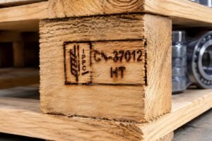 Close-up of a valid IPPC wheat stamp on a heat-treated wooden pallet used for bearing exports