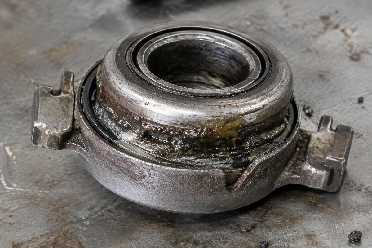 Photo of a failed clutch release bearing showing grease leakage and contaminant ingress